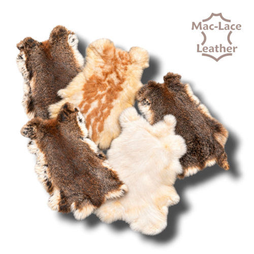 Rabbit fur skins in natural colours and white arranged with their full outlines visible